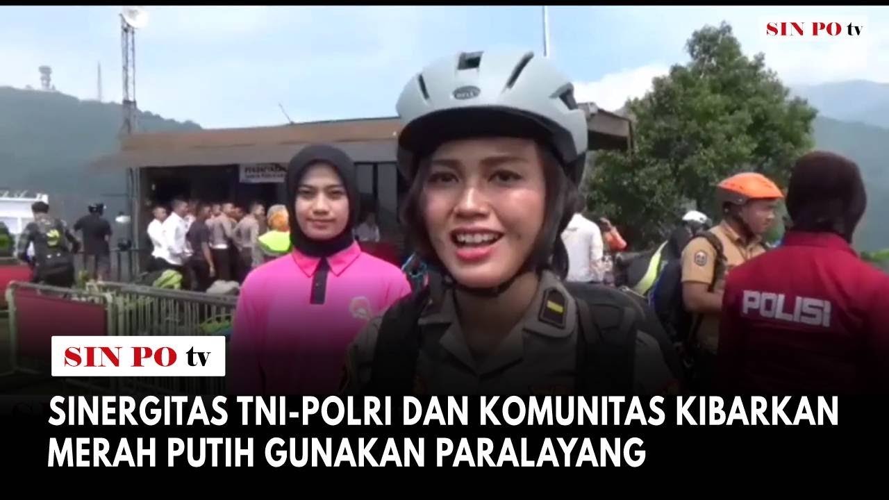 Sinergitas TNI-Polri Dan Komunitas Kibarkan Merah Putih Gunakan Paralayang
